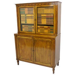 A Regency pale Mahogany and Ebony inlaid bookcase attributed to George Oakley.