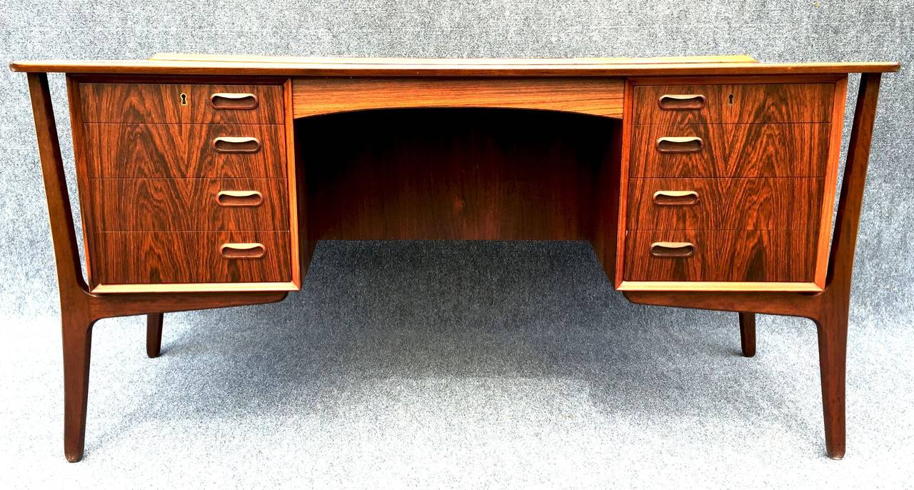 A beautiful double side desk, 8 drawers on the concave side, and a cupboard and shelf on the convex side. All in great condition.