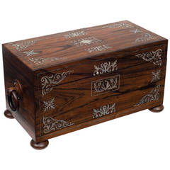 A rosewood and Mother of Pearl tea caddy