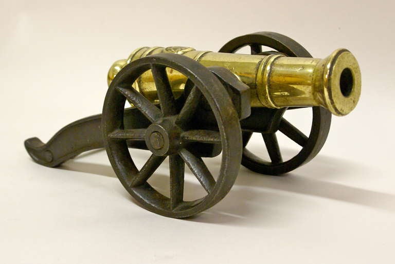 Grand Tour A Victorian brass ornamental cannon on cast iron carriage