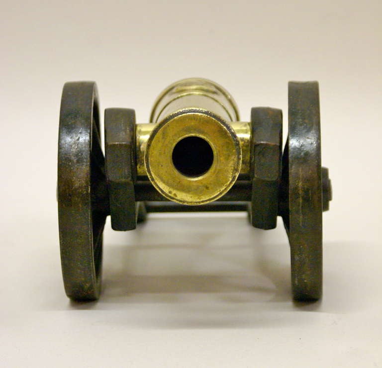 Brass A Victorian brass ornamental cannon on cast iron carriage