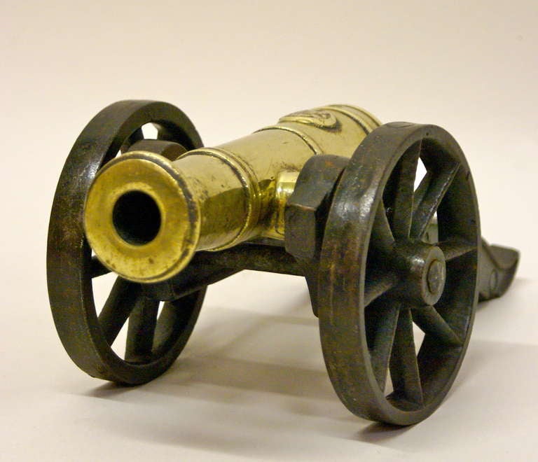 French A Victorian brass ornamental cannon on cast iron carriage