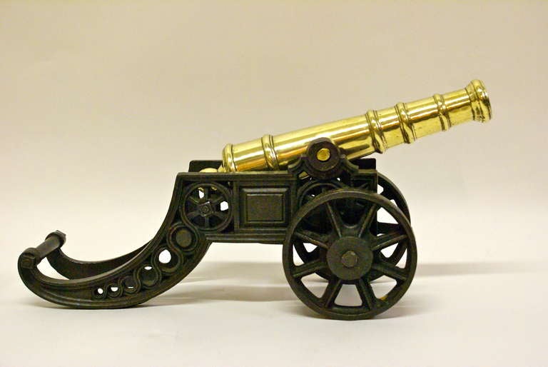Grand Tour A Victorian brass ornamental cannon on cast iron carriage.