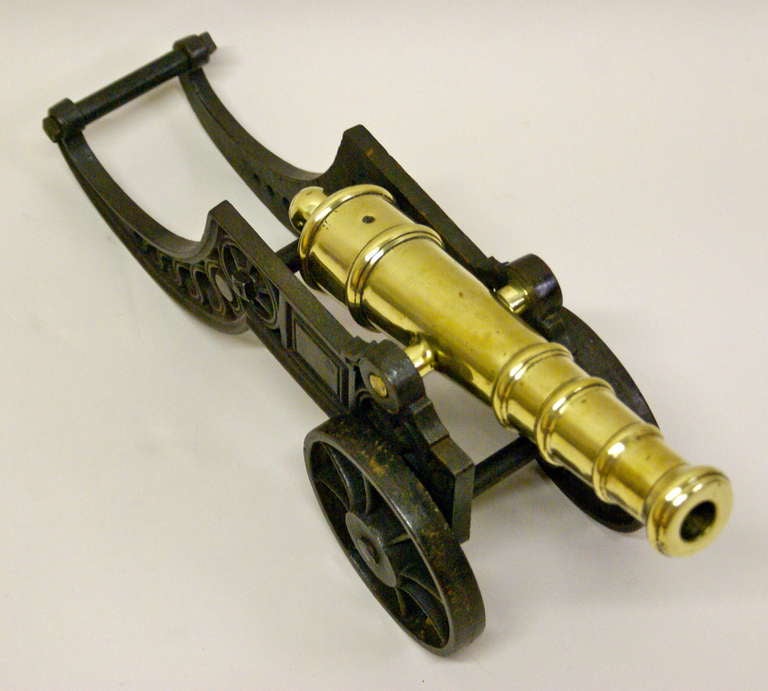 19th Century A Victorian brass ornamental cannon on cast iron carriage.