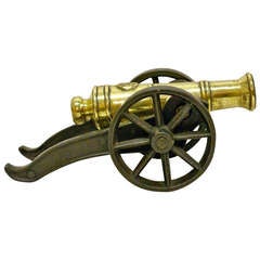 A Victorian brass ornamental cannon on cast iron carriage