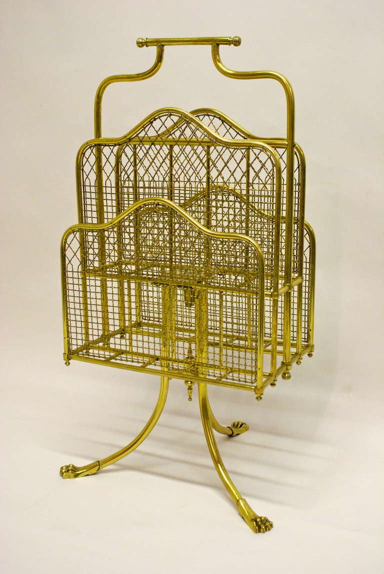 The four division revolving top with carrying handle is supported on a tripod base with out-swept legs terminating in lions paw feet.