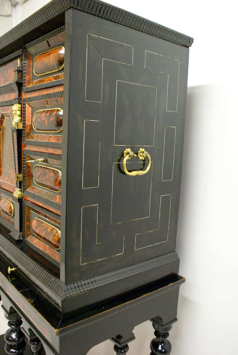 A late 17th Century Flemish Tortoise shell and ebony cabinet on stand. 1
