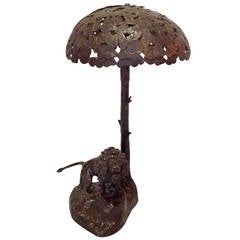 Lampada in bronzo dell'inizio del XX secolo raffigurante un leone sotto una chioma d'albero