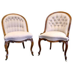A superb matched pair of Victorian walnut tub chairs
