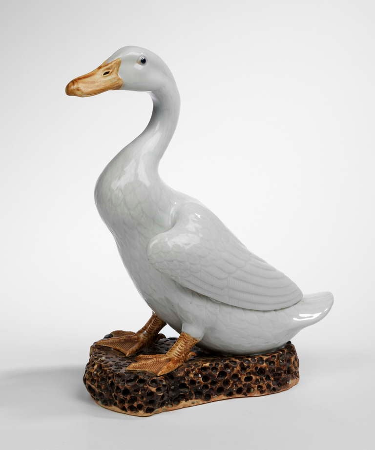 A very charming Chinese white duck on a rocky base. 
