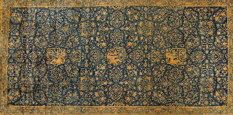 Agra are among the finest Indian carpets, At the center of the field a grand gold medallion with arabesque detail sprouts complex finials, balanced by ivory corner pieces with similarly elaborate internal detail. Vine scrolls writhe gracefully