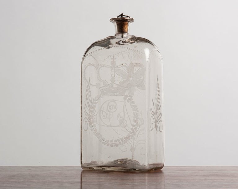 18c. glass decanter with a coat of arms and ornament itched on the front and back.