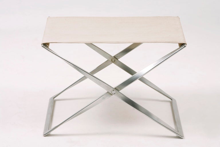 Elegant steel legs twisting 180°, original linen canvas seat cover.