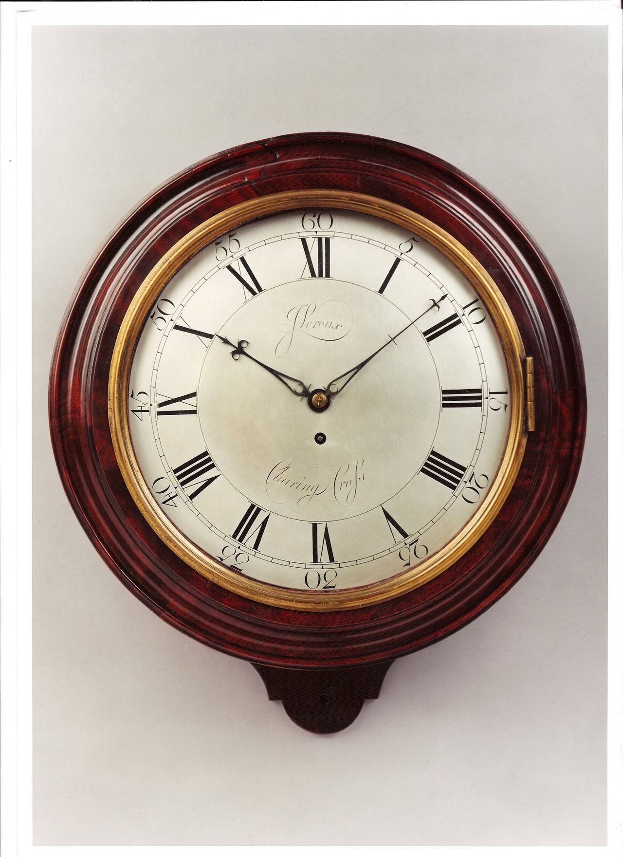 A George III period antique mahogany silvered dial wall timepiece. The 12 inch signed, silvered and engraved dial with blued steel hands, surrounded by the molded wood bezel. The eight day movement with tapered plates and anchor escapement.

John