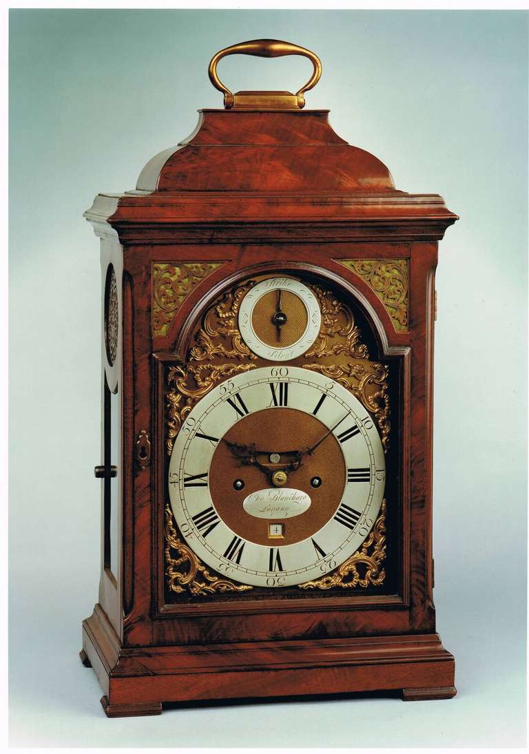 A fine antique George II period mellowed mahogany striking bracket clock, the arched brass dial and verge movement both signed Charles Blanchard, London. The clock is standing on block feet, has glazed sides and an inverted bell top with a brass