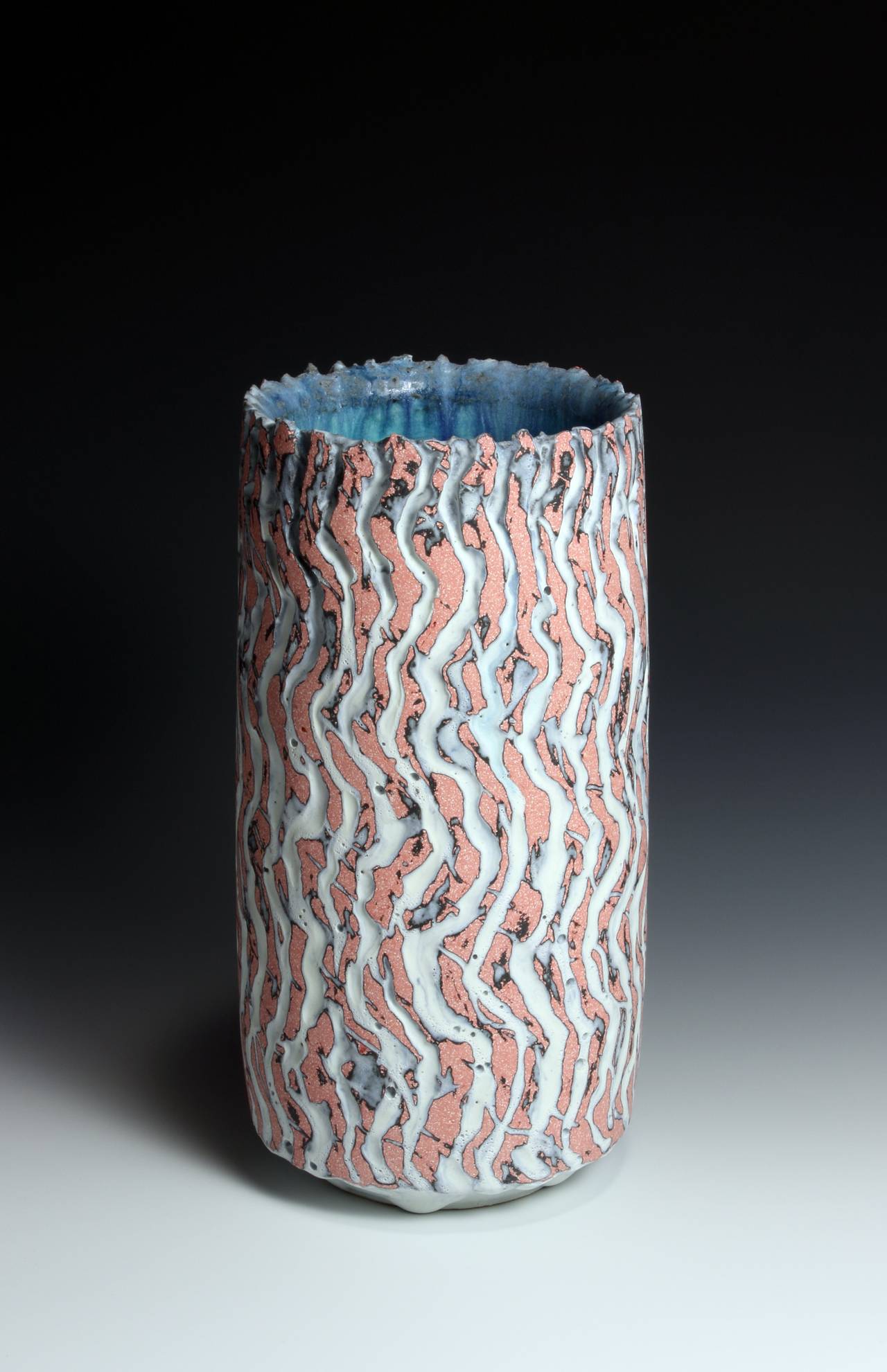 Pink and Black Cylindrical Vessel
