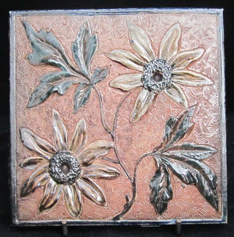 Tile decorated in relief with flowers and foliage. Unmarked, dated 1881. Plaster to rear and edges. 

MARTIN BROTHERS (1873-1914)