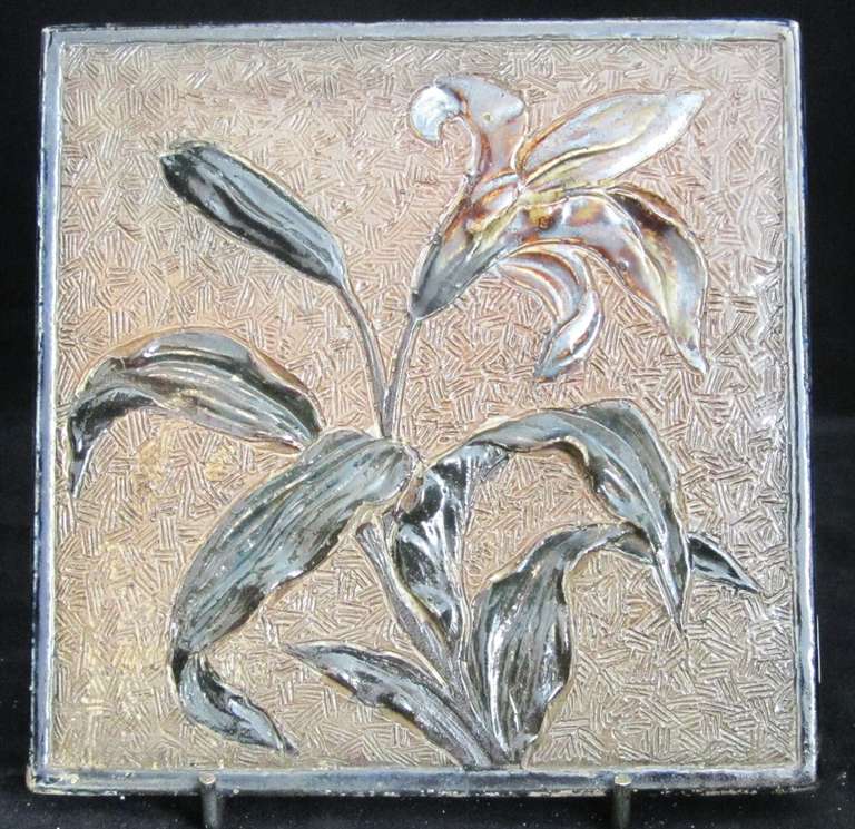 Tile decorated in relief with flowers and foliage. Unmarked, dated 1881. Plaster to rear and edges. 

MARTIN BROTHERS (1873-1914)