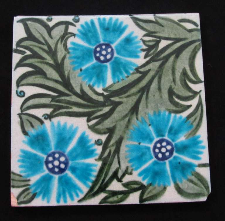 William De Morgan Tile decorated with 3 flowers design - chips to 2 corners