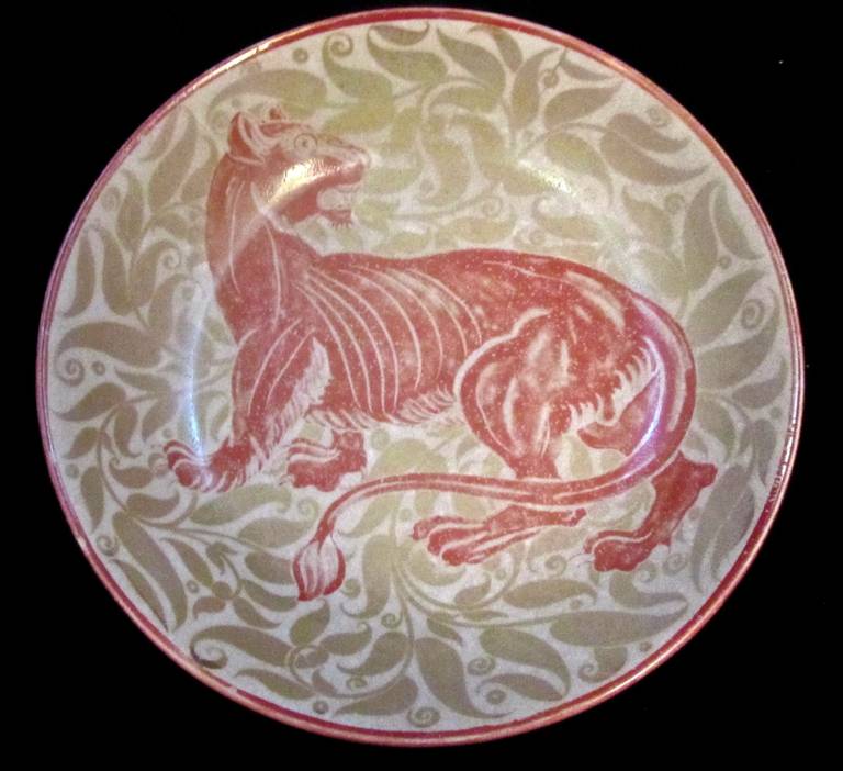 William De Morgan Double Lustre Dish decorated with a Lioness. Hairline crack to the rim. Signed by Charles Passenger