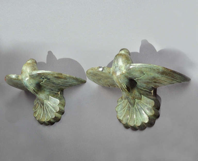 Pair Of Art Deco Bronze Sconces in green patina representing stylized flying birds. Circa 1930 - 1940.