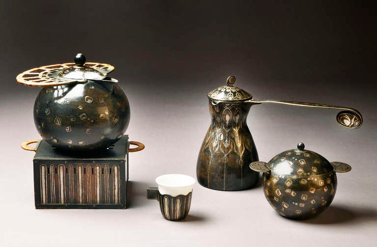 Rare and exceptional turkish style tea service in brown and silver patinated copperware comprising one cup, one sugar basin, one teapot and its stove and one coffee pot decorated with geometric patterns. The sugar basin, the coffee pot and the