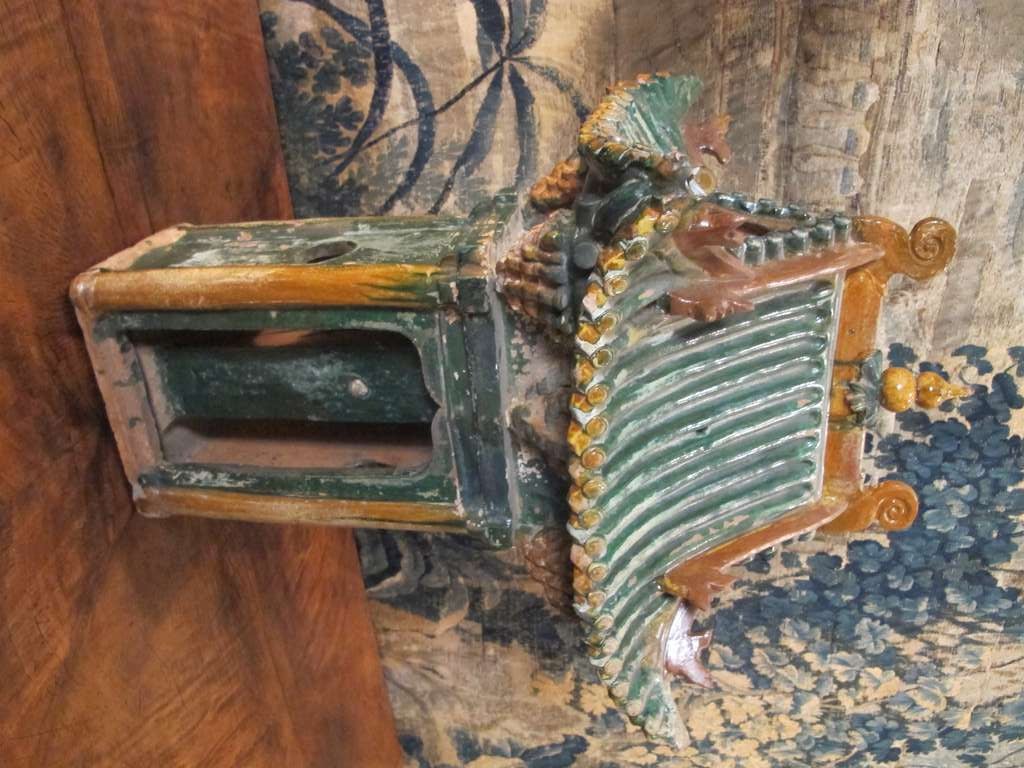 Chinese Sancai-glazed pottery temple with elaborate roof design, surmounting 4 columns framing a pair of ogee arches and a central pillar.  Ming Dynasty (1368-1644).  26