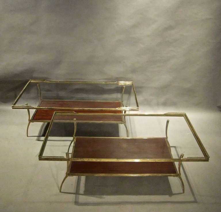 An exceptional near pair of brass and mahogany coffee tables with fretted gallery tops.
