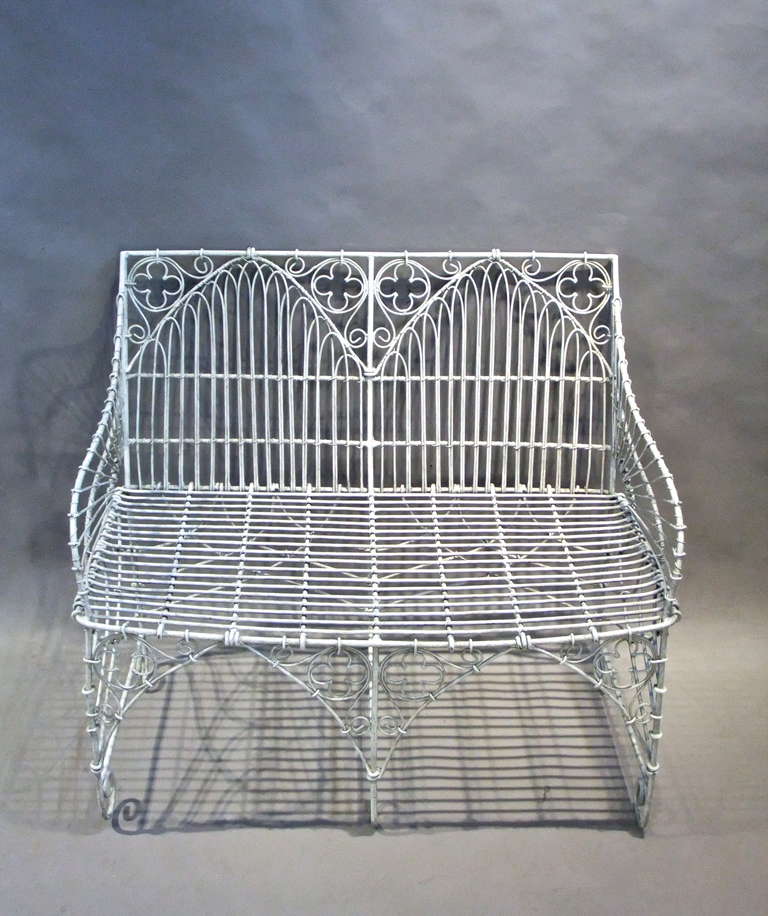 A very elegant 1930's white painted wire work Neo-Gothic two seater garden bench.