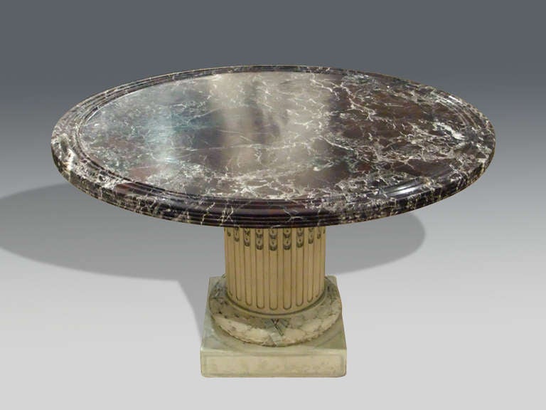 1930's Louis XVI revival painted centre table with carved column base decorated with swags supporting an impressive lipped and dished rouge marble top.
