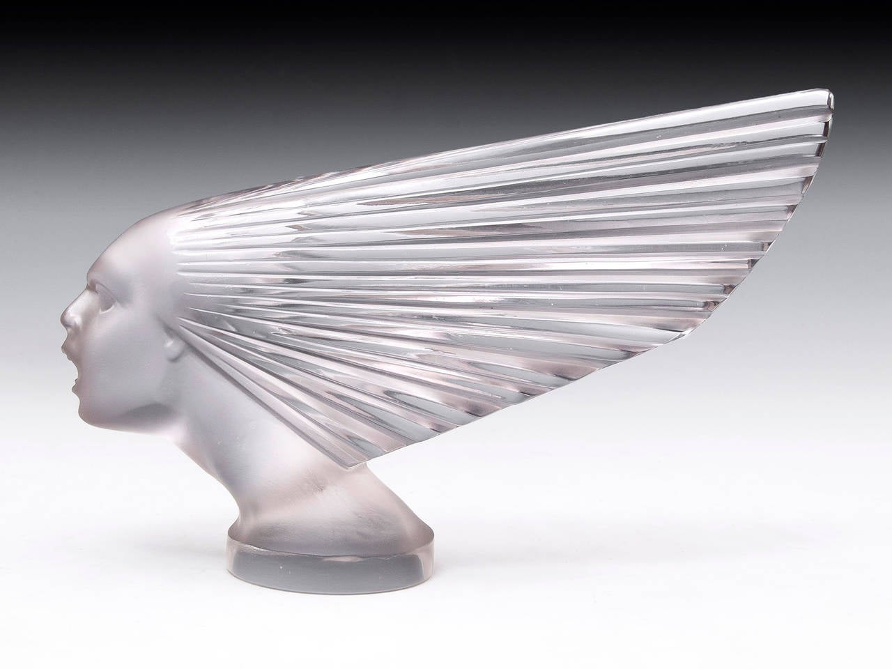 A Rene Lalique 'victoire' or 'Spirit of the wind' car mascot, a figure head with strong art deco lines featuring clear and frosted glass. This Is a genuine R. Lalique Mascot, its has had professional restoration as there was damage to the hair, nose