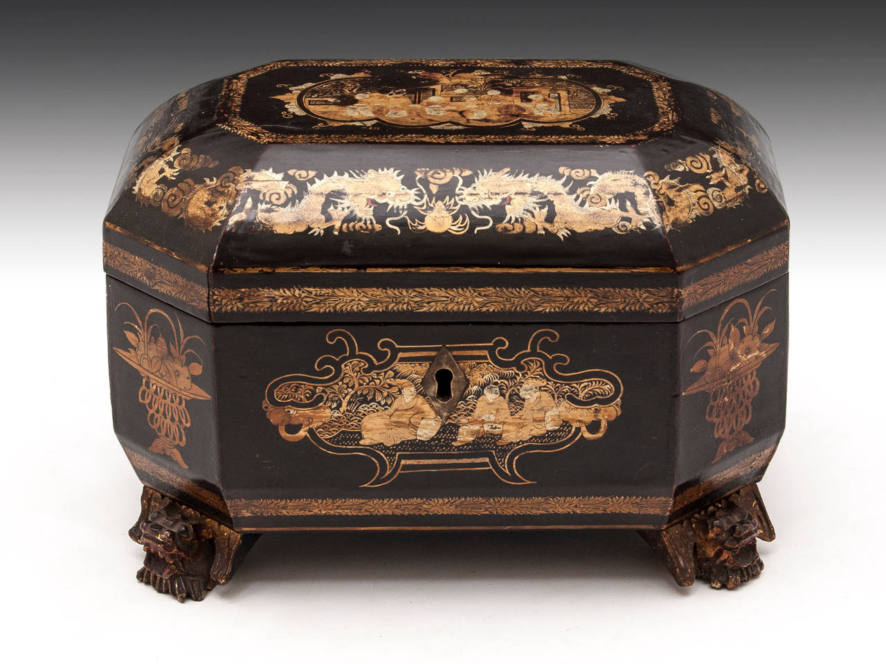 Chinese lacquer Tea Caddy standing on four carved dragon feet with beautiful Chinoiserie panels. 

The interior features two removable paktong caddies with bone handle lids. 

Shipping Cost: 
United Kingdom £25 
Europe £65 
International £85