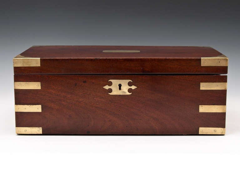 Large Mahogany Writing Slope by T.Handfords, London with brass reinforced corners, two brass escutcheons and flush fitting carrying handles which fit neatly into both sides of the writing box.

The interior has its original green baize writing