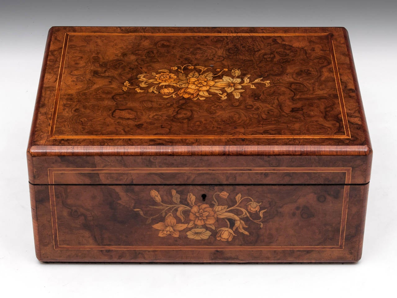 Burr Walnut Jewellery Box with beautiful inlaid flower designs, a tulipwood banding framing the top & front and edged with cross banded tulipwood. 

The interior of the box is lined with dark teal silk velvet and silk paper dividers. Featuring a