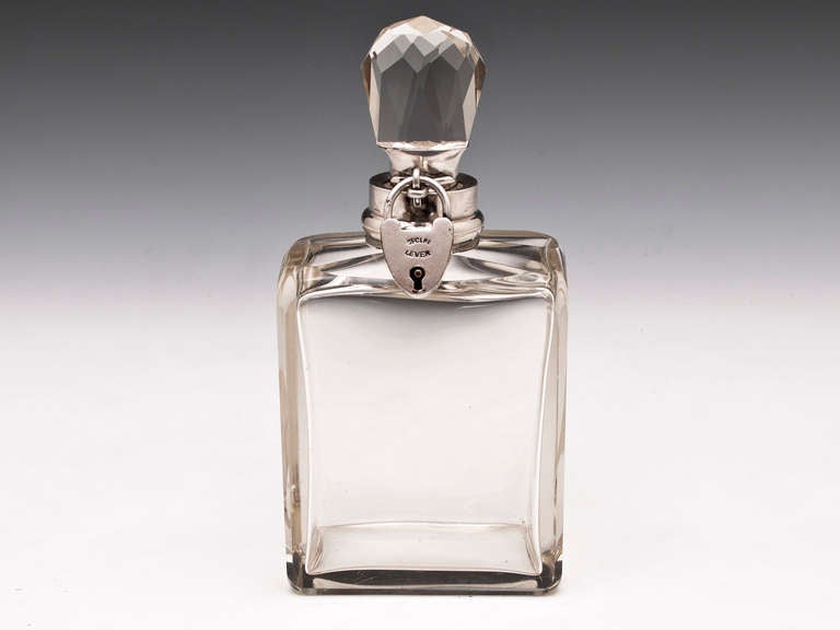 Sterling Silver Glass Decanter By important famous silversmiths Hukin & Heath hallmarked Birmingham 1906

This stunning Decanter has a faceted stopper with sterling silver collar and a working lockable heart shaped padlock with a tasselled key.