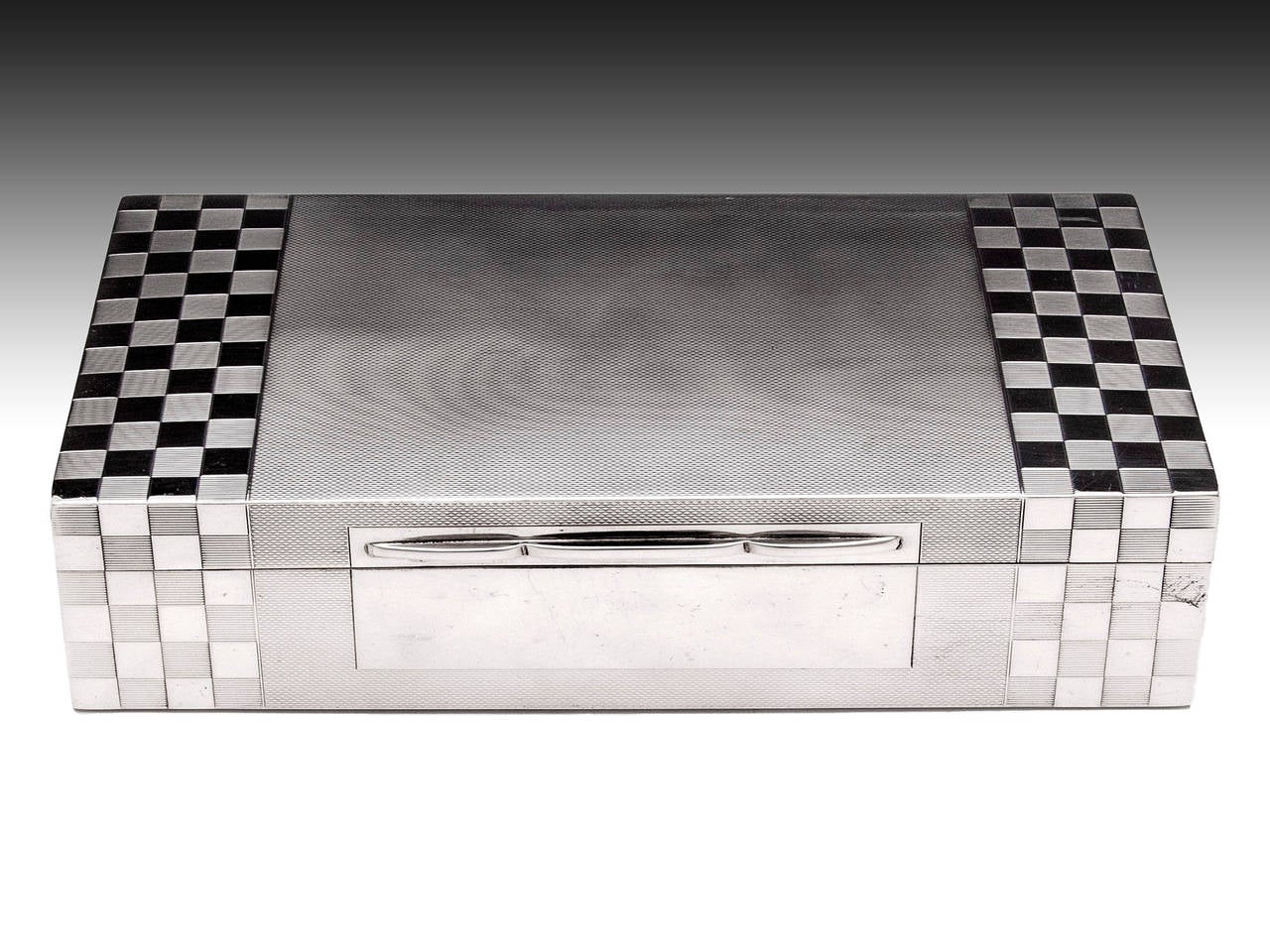 Sterling silver cigarette case by Birmingham silversmith A. Wilcox. 

The case features a textured finished with a chequered pattern on the front and top. The interior is lined with cedar wood with a removable divider. 

There is a small bit of