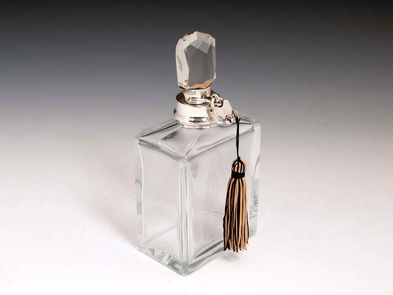 Art Deco Sterling Silver Glass Decanter By important famous silversmiths Hukin & Heath hallmarked Birmingham 1934. 

This stunning Decanter has a faceted stopper with sterling silver collar and a working lockable padlock with a tasselled key.