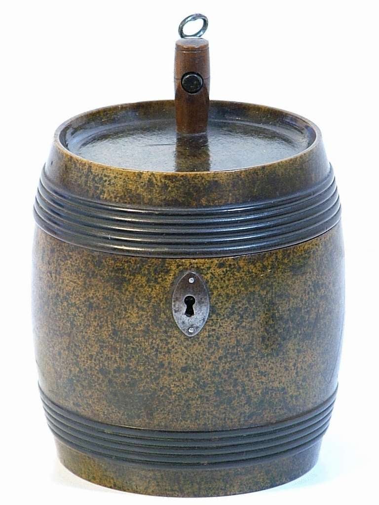 Exquisite and unusual Tea Caddy in the shape of a Wine Barrel with ebonised strapping. The escutcheon, lock and hinge are all made of iron. The key to the caddy is housed in the tap. 

The interior of this rare Barrel Tea Caddy appears to have
