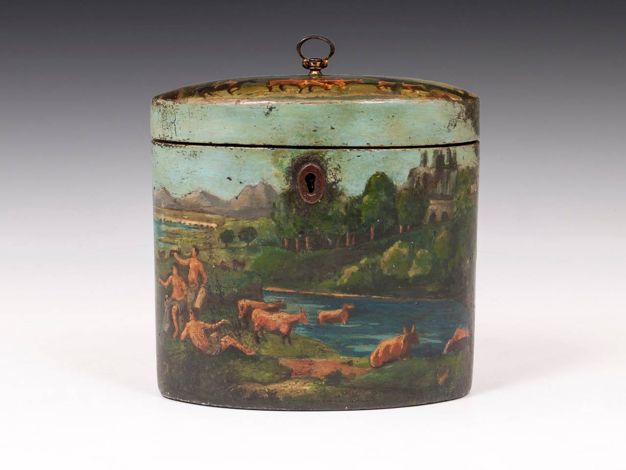 Papier Mache oval tea caddy with naively painted rural scene. The back of the Caddy depicts families gathering to look at some kind of spectacle. 

Shipping Cost: 
United Kingdom £25 
Europe £45 
International £65