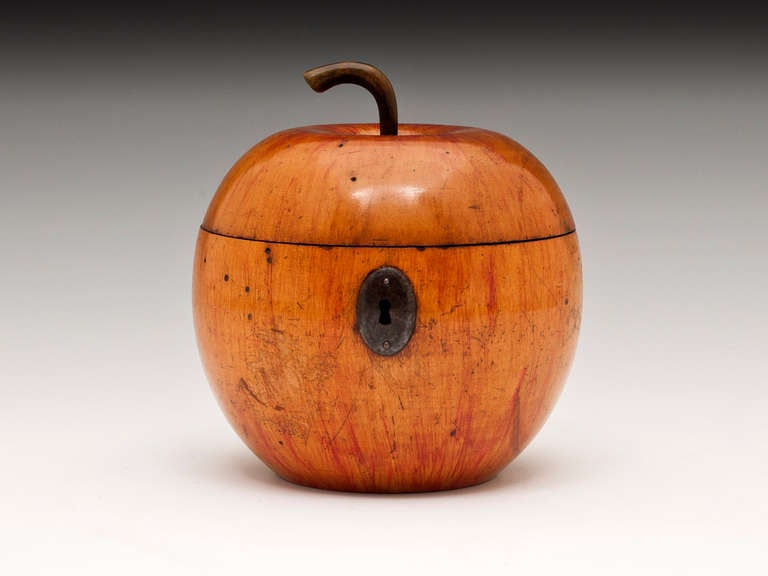 Apple tea Caddy with wonderful red blushing, replacement hinge, lock and escutcheon.

The apple tea caddy still has traces of tin lining, comes with a fully working lock and tasselled key.