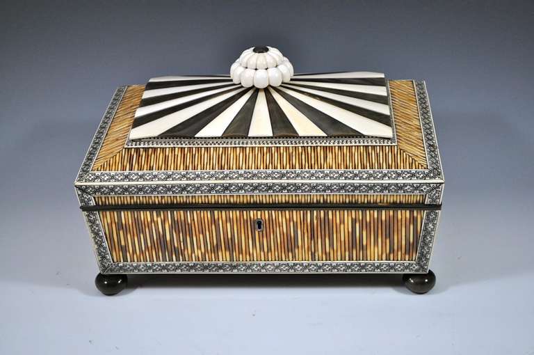 Large Anglo Indian Vizagapatam Ivory, Horn & Porcupine Quill work Box 

Very eye-catching sewing box from Vizagapatam in India. Has engraved lac filled borders which frame the porcupine quills, and has a starburst radiating top of Ivory & buffalo