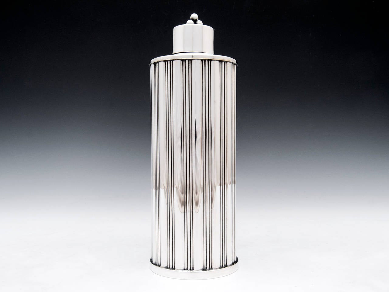 Art Deco Silver plate cocktail shaker with striking vertical line design. 

Shipping Cost: 
United Kingdom £25 
Europe £45 
International £65