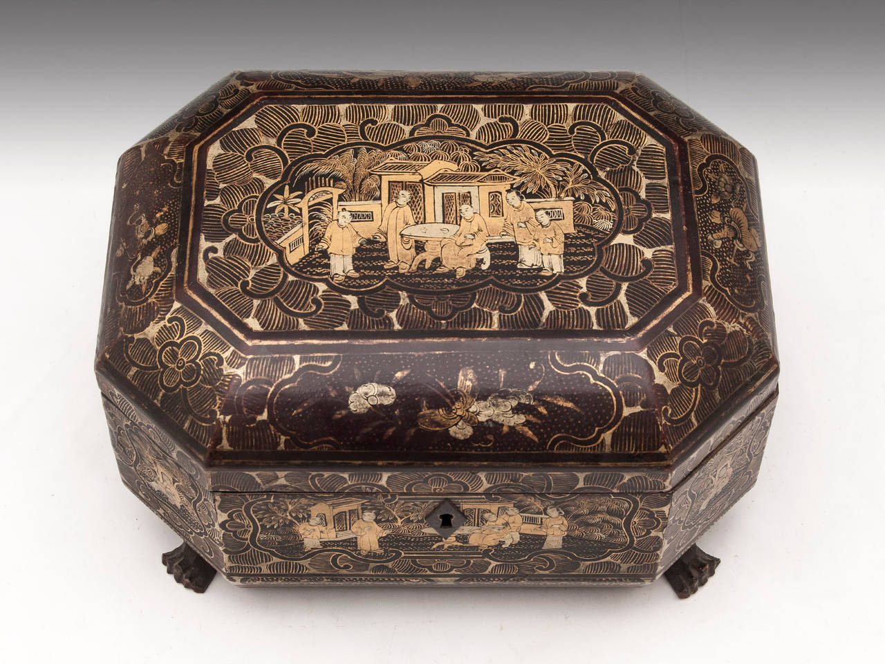 Chinese lacquer Tea Caddy standing on four carved dragon feet with beautiful Chinoiserie panels. 

The interior features two removable paktong caddies with bone handle lids. 

Shipping Cost: 
United Kingdom £25 
Europe £65 
International £85