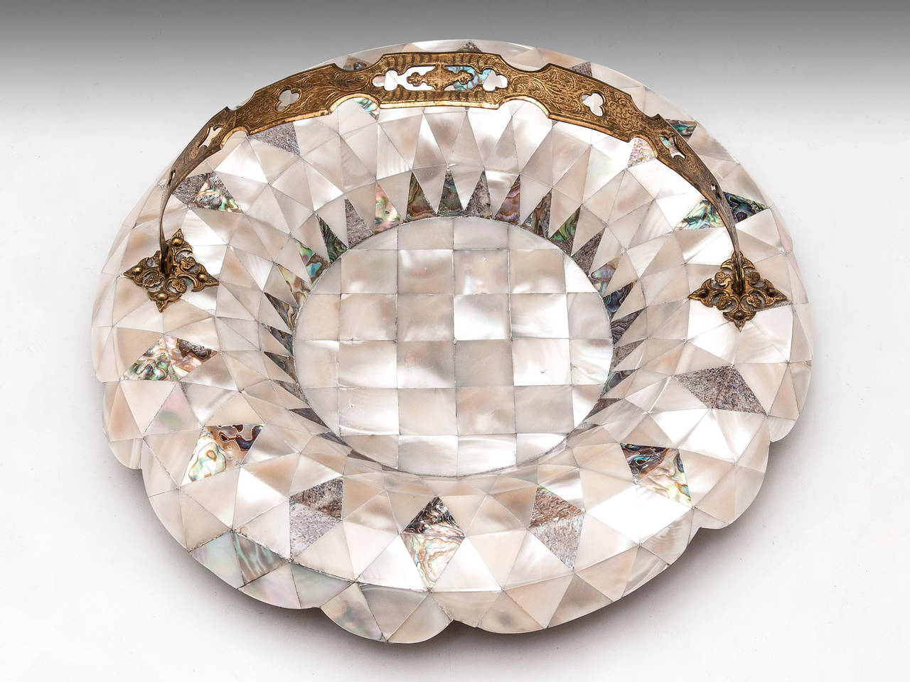 Unusual Bowl adorned with segments of Mother of Pearl and Abalone and featuring a ornate brass carry handle. 