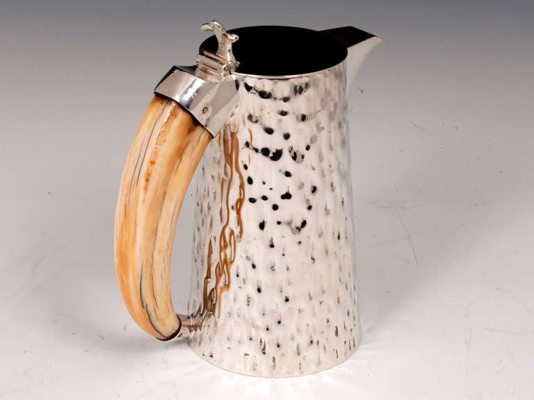 Hukin and Heath Silver Plated lidded jug with embossed bark decoration and Boar's tusk handle.

The base is signed by Hukin & Heath and stamped with number 10322.

Very decorative and practical Jug. 