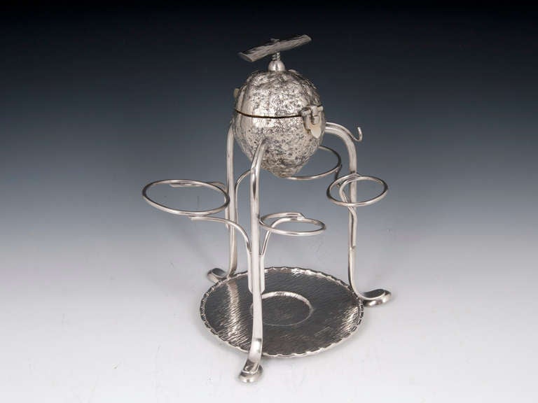 Rare silver plate lemon squeezer by famous silversmiths Hukin & Heath of Birmingham. The top in the form of lemon with a simulated branch for the handle which is attached to the thread of the interior juicer. 

Our feeling is this could well be by
