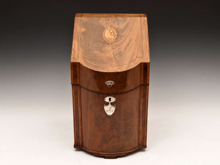 Knife box veneered in flame mahogany with silvered ring pull and engraved escutcheon. The top features a beautiful inlaid conch shell and the box stands on Ogee bracket feet.

Inside has been converted to a very high standard using mahogany and
