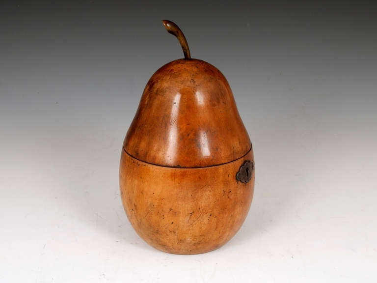 Tea Caddy in the shape of a Pear. It has iron escutcheon, hinge and lock. The elegant stalk at the top of the lid completes this beautiful Pear Tea Caddy. 

The interior of this Pear Tea Caddy still has traces of its original lead lining. 

This