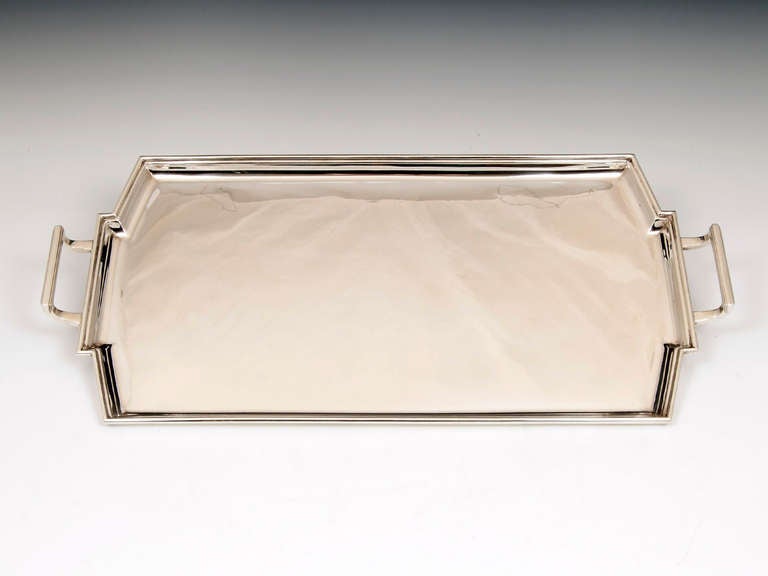 Art Deco Silver serving tray by sheffield silversmith Frank Cobb & Co 1934. 

This fine silver serving tray has a moulded edge, angled corners and oblong stepped Art Deco handles, its simple elegant lines are typical of its period and the