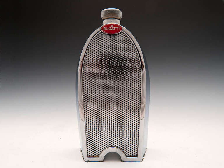 Chrome Bugatti Spirit Decanter with super red enamelled Bugatti badge, all incased around a single glass decanter. On the back of the decanter shows its spirit level so when removing its radiator screw top decanter lid you don't over fill.

This